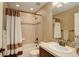 Bathroom featuring a shower-tub combo, single vanity, and dark bronze fixtures at 4784 Raven Run, Broomfield, CO 80023