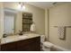 Bathroom with granite vanity, tile floors, and a shower behind the toilet at 4784 Raven Run, Broomfield, CO 80023