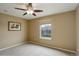 Neutral bedroom featuring carpet, window, ceiling fan, and light tan walls at 4784 Raven Run, Broomfield, CO 80023
