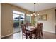 Dining room with wood table, chandelier, and patio access at 4784 Raven Run, Broomfield, CO 80023