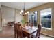 Dining room with wood table, chandelier, and view to outdoor patio at 4784 Raven Run, Broomfield, CO 80023