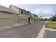 Exterior view showcasing the townhome's garages in a well-maintained community with street access at 4784 Raven Run, Broomfield, CO 80023