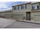 A row of garages offering ample parking and storage space, complemented by the home's exterior at 4784 Raven Run, Broomfield, CO 80023