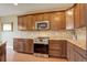 Stylish kitchen featuring stainless steel appliances, granite countertops, and wooden cabinetry for a modern look at 4784 Raven Run, Broomfield, CO 80023