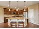 Open-concept kitchen with a breakfast bar, granite countertops, and stainless steel appliances for convenient cooking at 4784 Raven Run, Broomfield, CO 80023