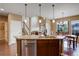 Open concept kitchen with island seating, granite countertops, and stainless steel appliances at 4784 Raven Run, Broomfield, CO 80023