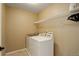 Laundry room with tile floor, wire shelving, and a washer and dryer set at 4784 Raven Run, Broomfield, CO 80023