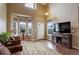 Inviting living room with hardwood floors, a bay window, and comfortable seating beneath a vaulted ceiling at 4784 Raven Run, Broomfield, CO 80023
