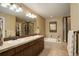 Bathroom featuring double sinks, a soaking tub, and a glass shower at 4784 Raven Run, Broomfield, CO 80023