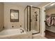 Elegant bathroom featuring a soaking tub, glass shower, and walk in closet at 4784 Raven Run, Broomfield, CO 80023
