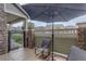 View of a fenced-in patio area with chairs and an umbrella, perfect for relaxing and enjoying the outdoors at 4784 Raven Run, Broomfield, CO 80023