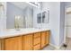 Bathroom featuring a double sink vanity with wood cabinets at 9585 Brentwood Way # D, Westminster, CO 80021