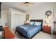 This bedroom features a comfy bed, a ceiling fan, bedside tables, and a double door closet at 5677 S Park Pl # C208, Englewood, CO 80111