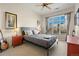 This bedroom features a comfy bed, a ceiling fan, bedside tables, and a window with a view at 5677 S Park Pl # C208, Englewood, CO 80111