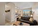 Inviting living room with a leather couch and lots of natural light, leading into the kitchen and work space at 5677 S Park Pl # C208, Englewood, CO 80111