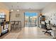 Open living space with modern kitchen, dining table, office area, and balcony access for easy living and entertaining at 5677 S Park Pl # C208, Englewood, CO 80111