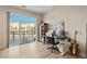 Bright office area with large window, built in storage and work space with a view of the balcony and scenery at 5677 S Park Pl # C208, Englewood, CO 80111