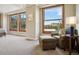 Bedroom with a neutral chair and ottoman by a large window with exterior view at 2245 Blake St # C, Denver, CO 80205