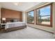 Bedroom featuring a platform bed, brick wall and a view from two large windows at 2245 Blake St # C, Denver, CO 80205