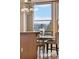 Sunlit dining area with large windows and a modern chandelier at 2245 Blake St # C, Denver, CO 80205