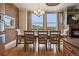 Bright dining room with hardwood floors, a modern chandelier, and a fireplace at 2245 Blake St # C, Denver, CO 80205