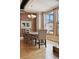 Charming dining room featuring a brick accent wall, hardwood floors and large windows offering city views at 2245 Blake St # C, Denver, CO 80205