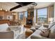 Living room featuring hardwood floors, a fireplace, and a dining area at 2245 Blake St # C, Denver, CO 80205