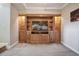 Living room with a large wooden entertainment center featuring open shelves and a large screen television at 2245 Blake St # C, Denver, CO 80205