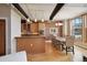 Open concept living space with exposed duct work, brick wall, and a dining area near the large windows at 2245 Blake St # C, Denver, CO 80205