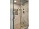 Walk-in shower with glass door, gray tile, and shower head at 2245 Blake St # C, Denver, CO 80205