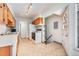 Kitchen with wood cabinets, white appliances, and a double sink at 5610 E Amherst Ave, Denver, CO 80222