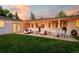 Backyard with string lights, outdoor furniture, and a lush green lawn at 3001 S Josephine St, Denver, CO 80210