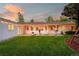 Backyard with string lights, outdoor furniture, and a lush green lawn at 3001 S Josephine St, Denver, CO 80210