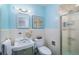 Vintage blue bathroom features a retro sink, toilet and shower stall at 3001 S Josephine St, Denver, CO 80210