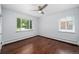 Neutral bedroom features hardwood floors, white walls and trim, and two large windows at 3001 S Josephine St, Denver, CO 80210