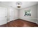 Empty bedroom with hardwood floors, white trim, and a large window at 3001 S Josephine St, Denver, CO 80210