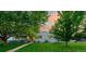 Charming single-story home with lush front yard and mature trees, beautiful landscaping at dusk at 3001 S Josephine St, Denver, CO 80210