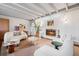 Stylish living room featuring a fireplace, exposed beam ceiling, and modern, comfortable furniture at 3001 S Josephine St, Denver, CO 80210