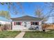 Inviting single story home with red shutters and front patio beneath a clear blue sky at 257 2Nd St, Frederick, CO 80530
