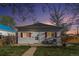 Charming single story home with red shutters and inviting front patio under a twilight sky at 257 2Nd St, Frederick, CO 80530