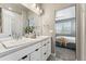 Double vanity bathroom with view into bedroom at 6771 Canosa St, Denver, CO 80221