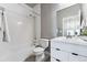 Clean bathroom with white tiled walls, a bathtub, toilet, and vanity at 6771 Canosa St, Denver, CO 80221