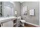 Bathroom with white subway tile, a bathtub, and a vanity with a barn door at 6771 Canosa St, Denver, CO 80221