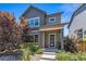 Well-maintained two-story home with modern architecture, a landscaped yard, and an inviting front porch at 6771 Canosa St, Denver, CO 80221