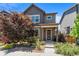 Charming two-story home features modern architecture, landscaped yard, and inviting front porch at 6771 Canosa St, Denver, CO 80221