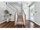 Foyer featuring hardwood floors, a staircase with white railings, and a stylish entrance at 6771 Canosa St, Denver, CO 80221