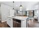 Modern kitchen with white cabinets, stainless steel appliances, and an island at 6771 Canosa St, Denver, CO 80221