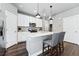 Modern kitchen with white cabinets, stainless steel appliances and an island at 6771 Canosa St, Denver, CO 80221