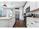 Modern kitchen with white cabinets, stainless steel appliances and an island at 6771 Canosa St, Denver, CO 80221