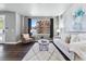 Cozy living room with large window, stylish decor, comfortable seating and hardwood floors at 6771 Canosa St, Denver, CO 80221